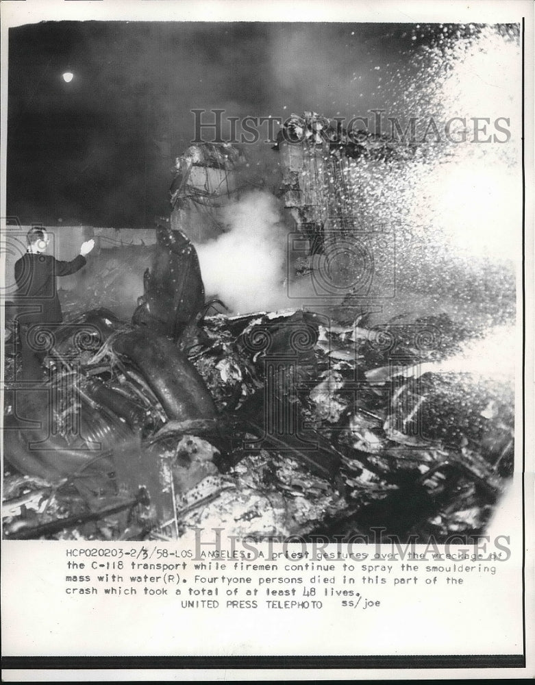 1958 Press Photo Priest Overlooks Wreck C-118 Firemen Transport Accident - Historic Images