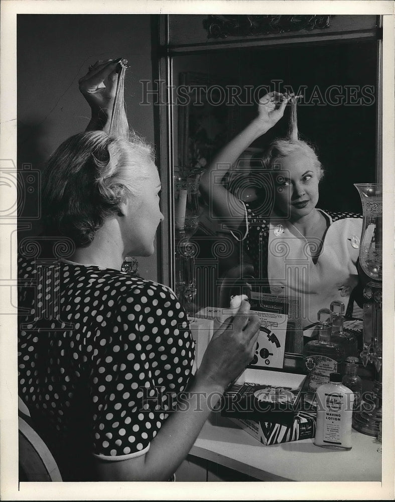 1948 Press Photo Woman Giving Herself a Permanent Curl - nea78204 - Historic Images