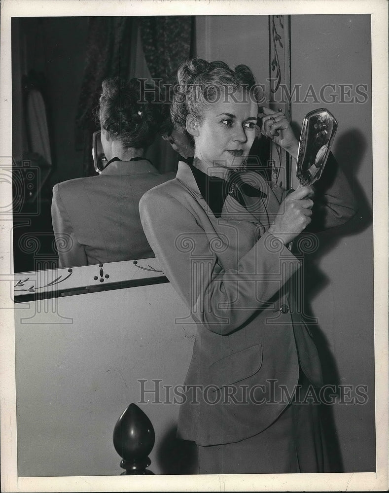 1948 Press Photo Lady Looking at Her Hair Style - nea78221 - Historic Images