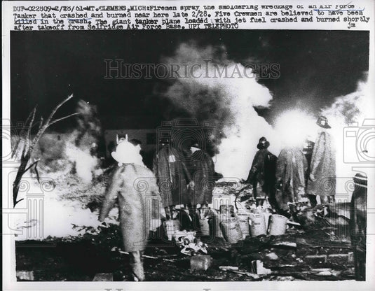 1961 Firemen spray the wreckage of an Air Force Tanker crashed. - Historic Images
