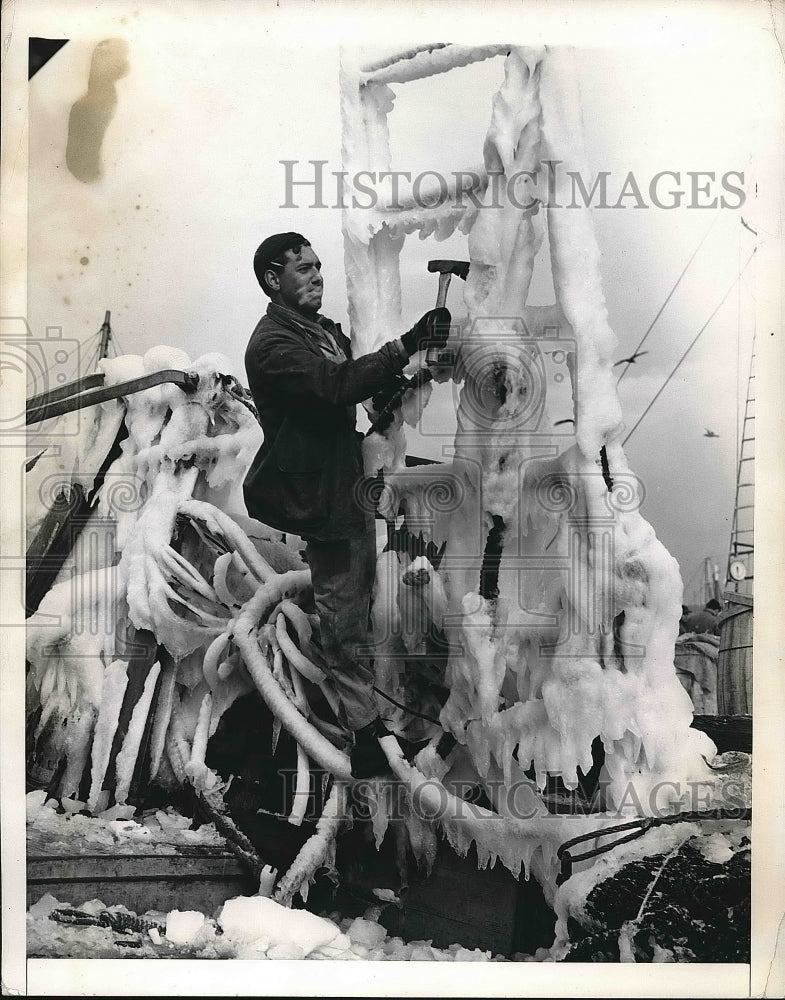 1942 Joseph LaRocco chops ice from a ships rigging  - Historic Images