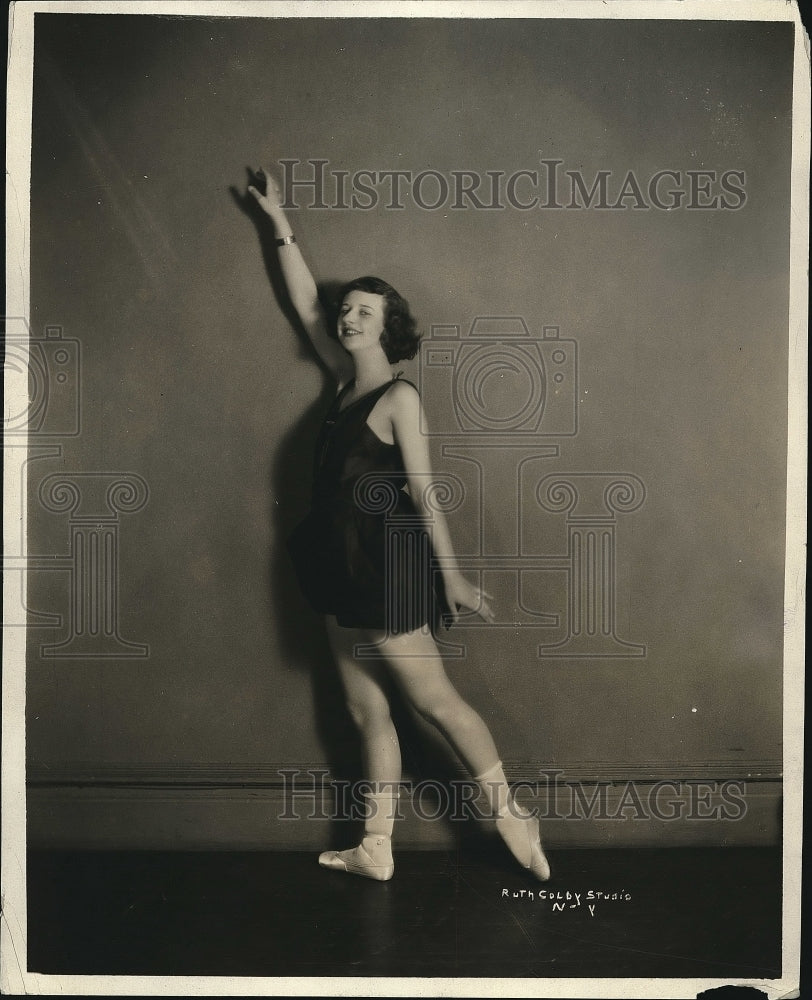 1924 A woman demonstrates exercise poses  - Historic Images