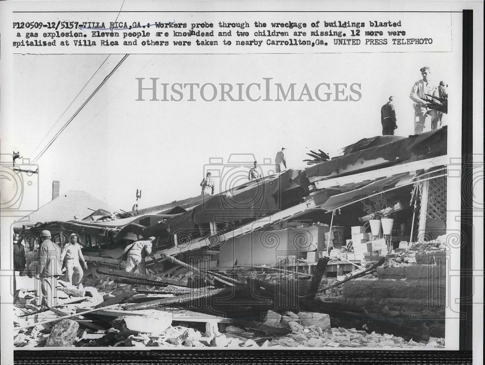1957 Workers at the wreckage of bldg.blasted in gas explosion. - Historic Images
