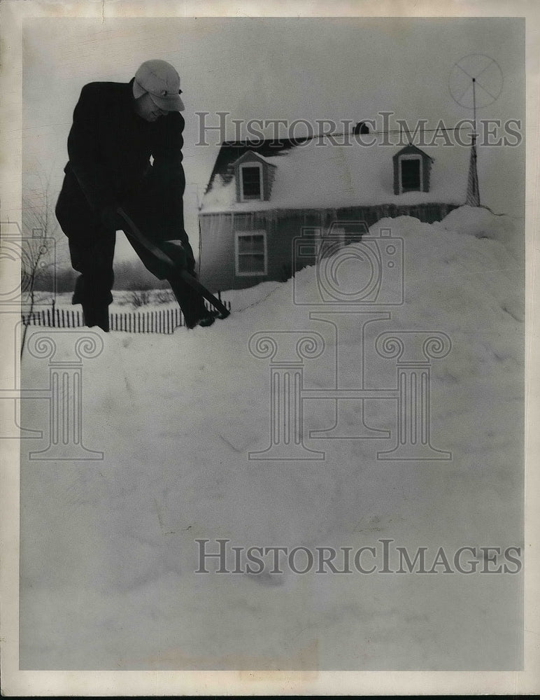 1958 John Boyle shoveling snow at his home on Wilson Mills Rd. - Historic Images