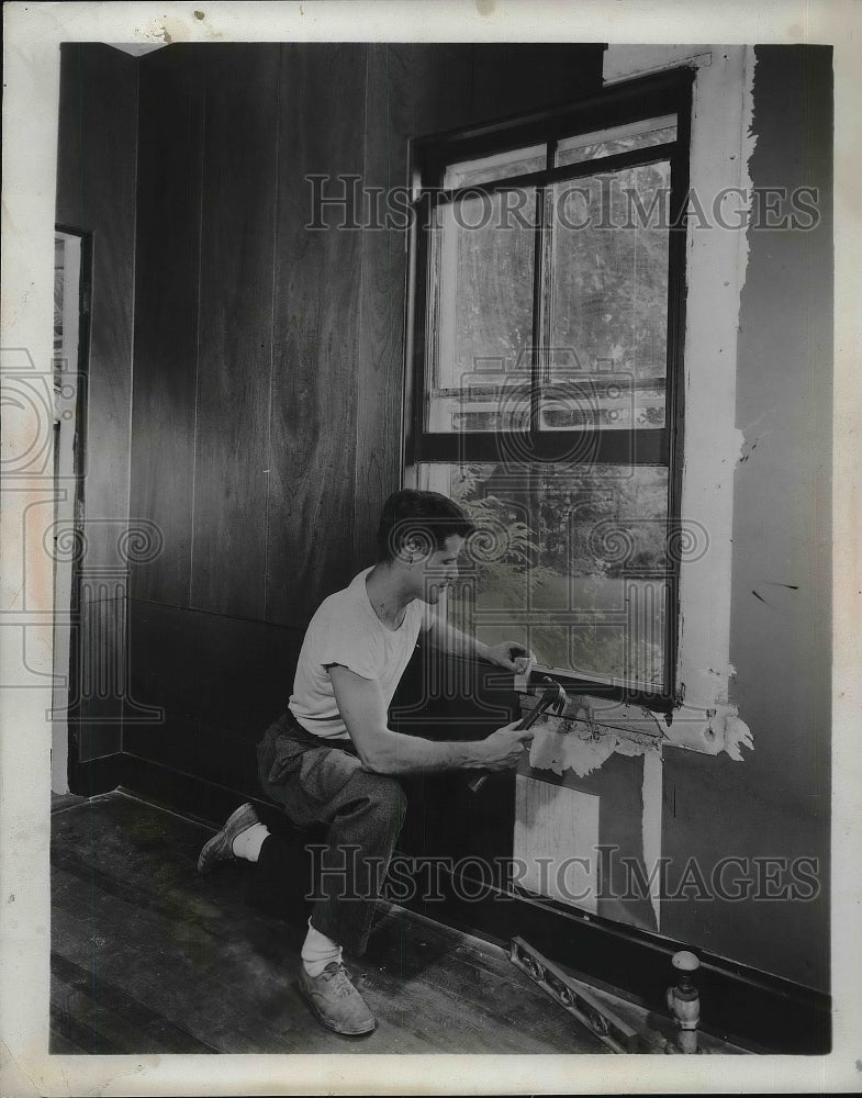 1953 A man renovating a house  - Historic Images