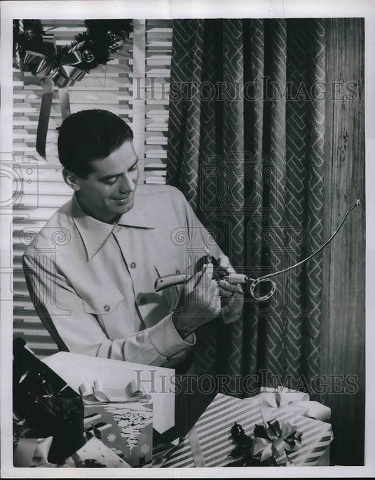 1951 Press Photo Man with a Christmas Gift of Midget Casting and Trolling Rod - Historic Images