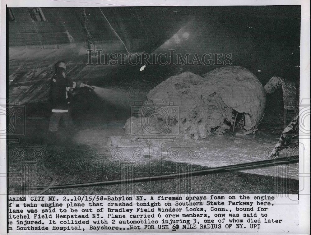 1958 Press Photo Firemen spraying foam onto engine of crashed plane - nea80287 - Historic Images