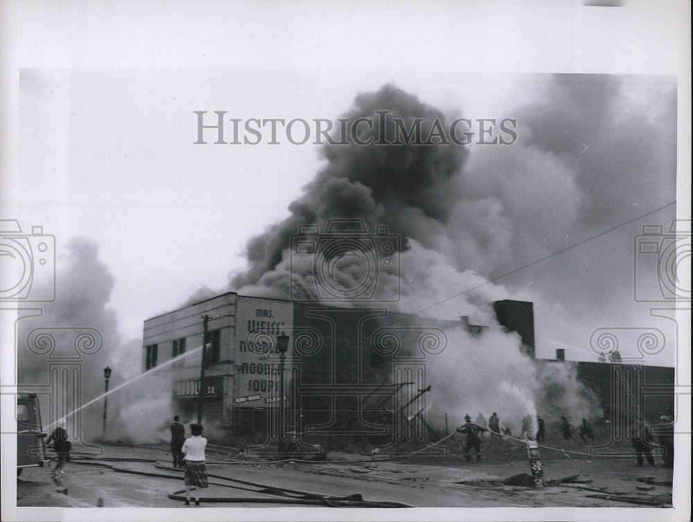 1961 building with smoke billowing out from Fire  - Historic Images