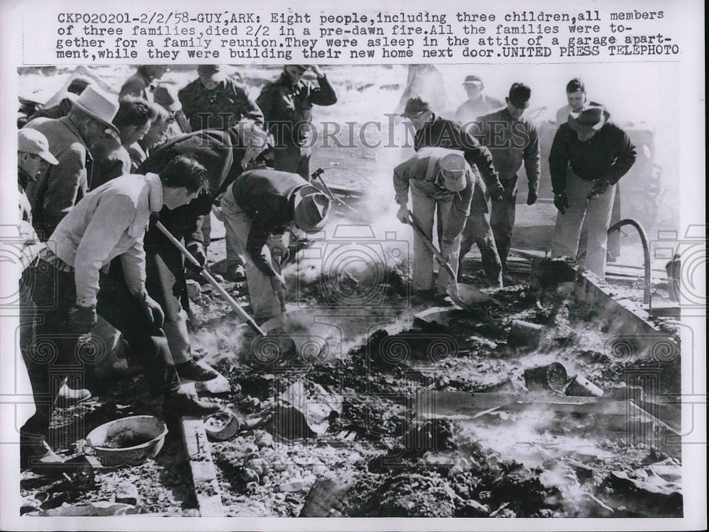 1958 People looking through remains of house fire  - Historic Images