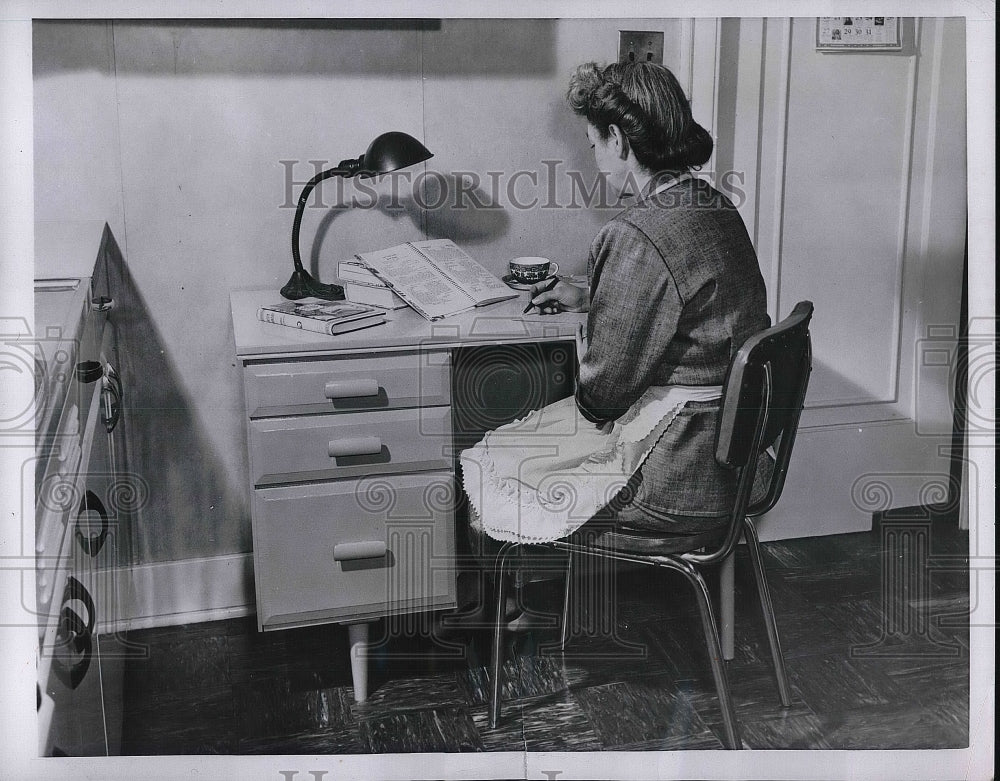 1954 Mrs. Bird Sitting in Finished Desk in her Kitchen  - Historic Images