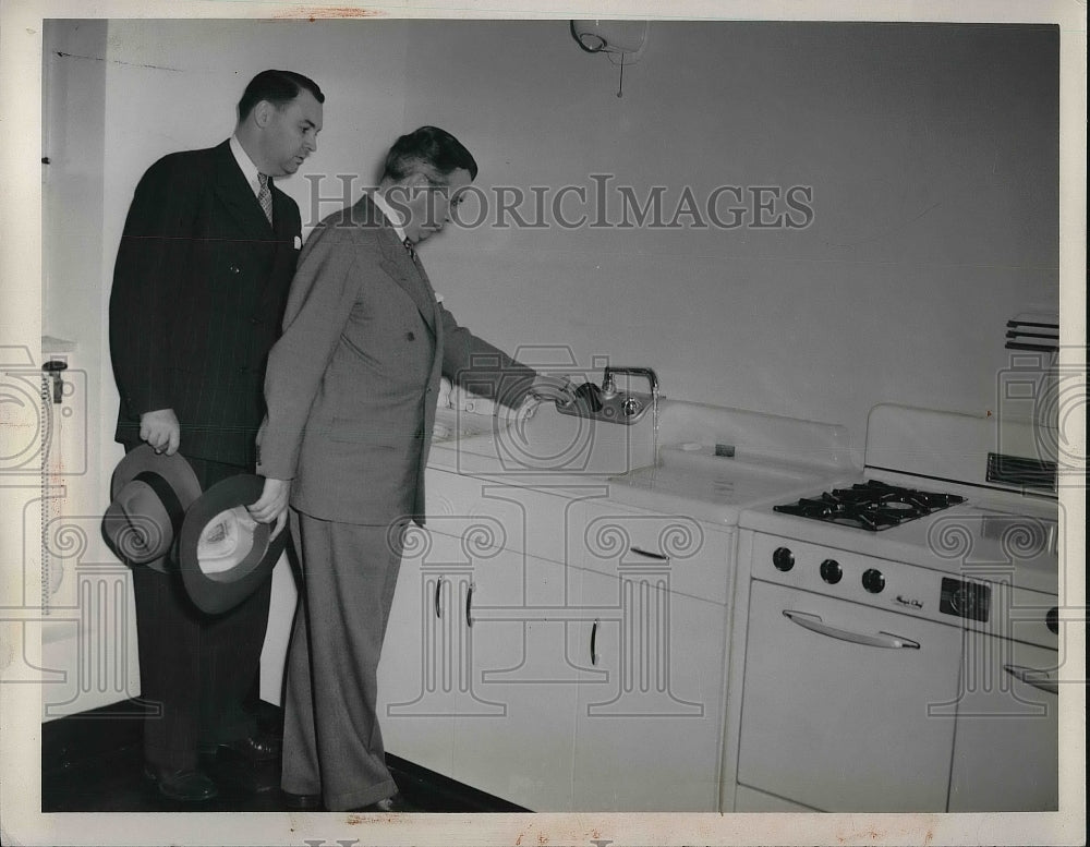 1947 Press Photo two men looking over a kitchen - nea81741-Historic Images