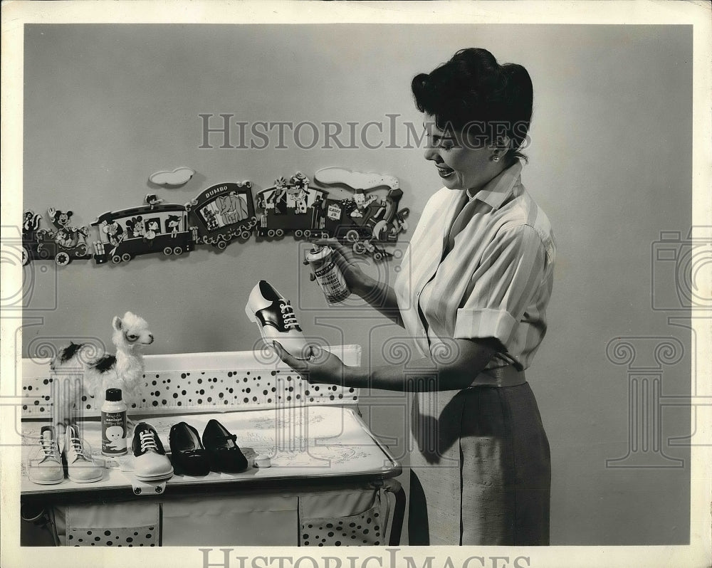 1959 A homemaker trying out spay for bacteria in a nursery - Historic Images