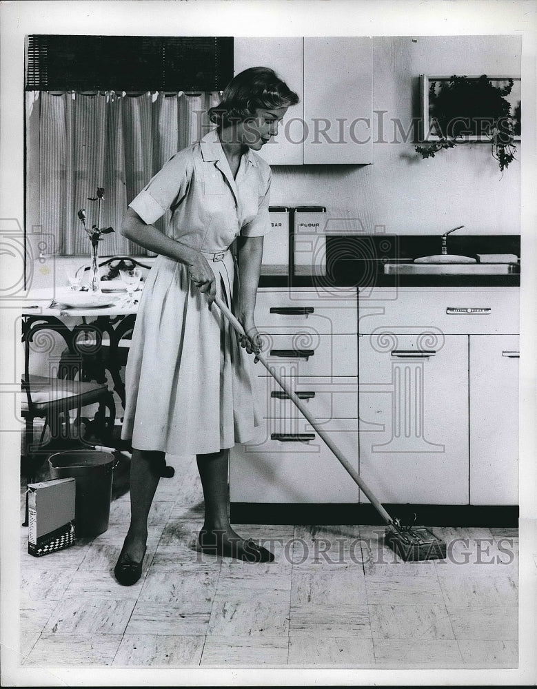 1958 A homemaker mopping kitchen floors  - Historic Images