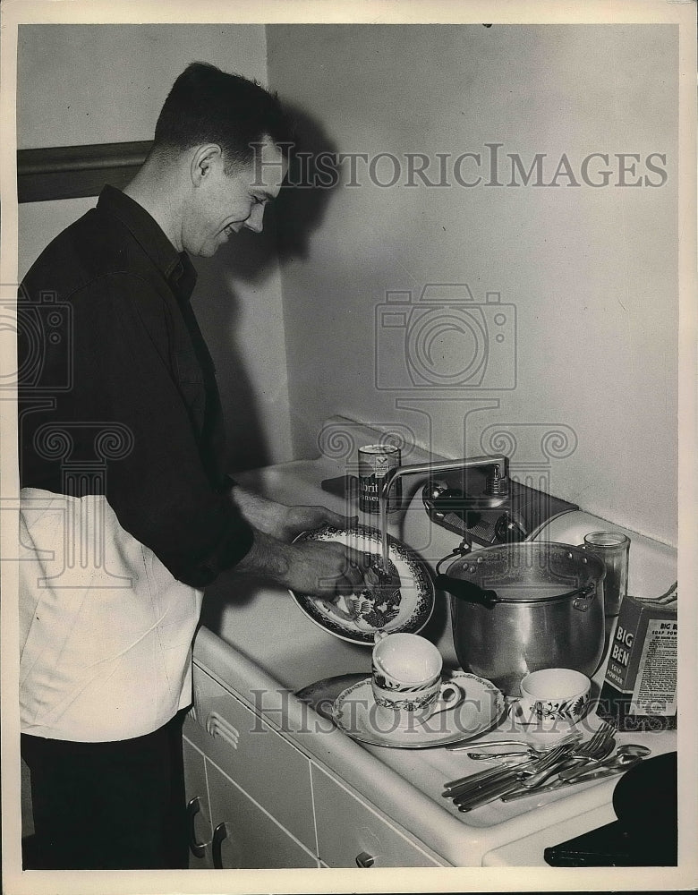 1949 Cleveland fireman Paul Gibbons does dishes after a meal - Historic Images