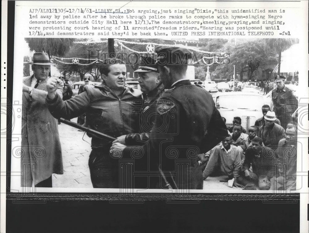 1961 Press Photo Protester being lead away by the police - Historic Images