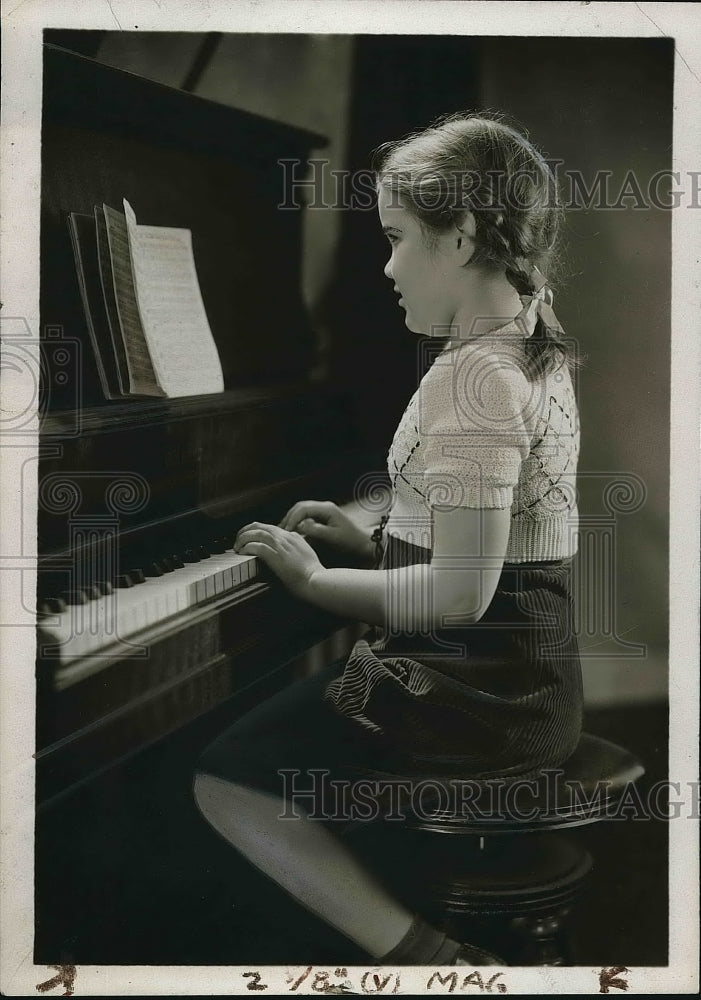 1939 A young girl playing the piano  - Historic Images