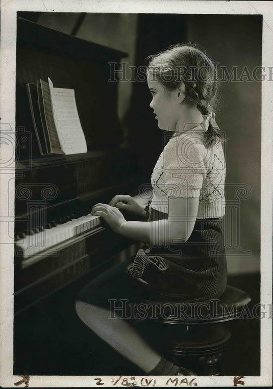 1939 A young girl playing the piano  - Historic Images