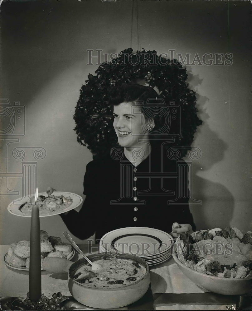 1942 Press Photo A woman sitting at a dinner table - nea83090 - Historic Images