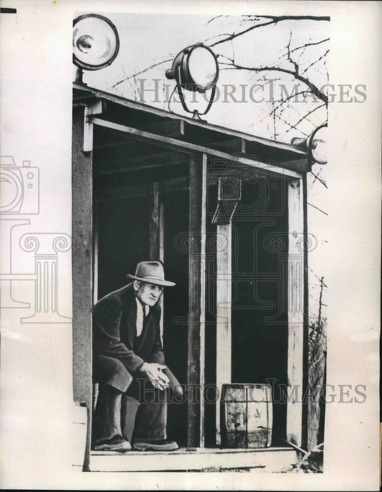 1945 Press Photo Morgan Lewis sitting alongside the river - Historic Images