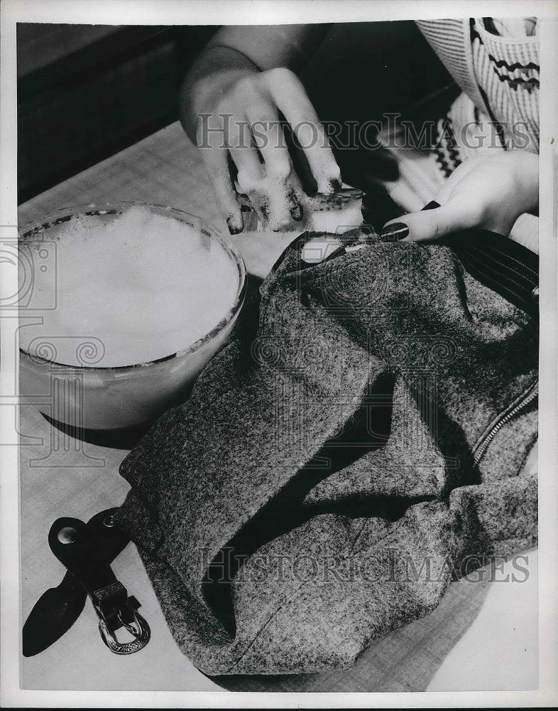 19552 Claiming spots off of clothing before washing  - Historic Images