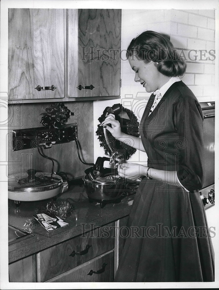 1955 A woman working in the kitchen  - Historic Images