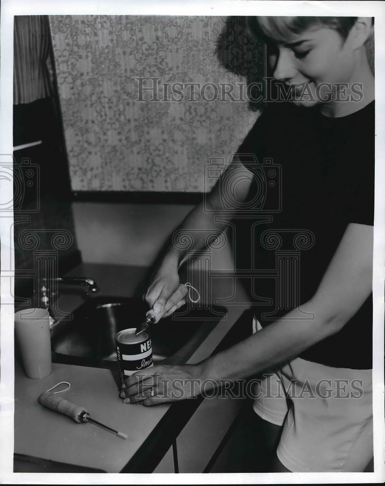 1969 A woman using a can opener  - Historic Images