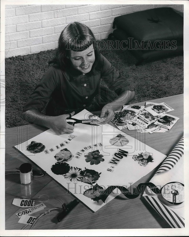 1959 A young girl making paper cutouts  - Historic Images