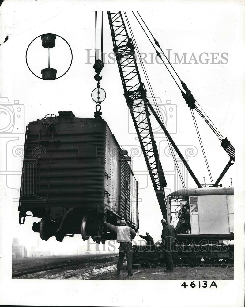 1961 Press Photo Freight Car supported by a pencil thin strand alloy Steel. - Historic Images