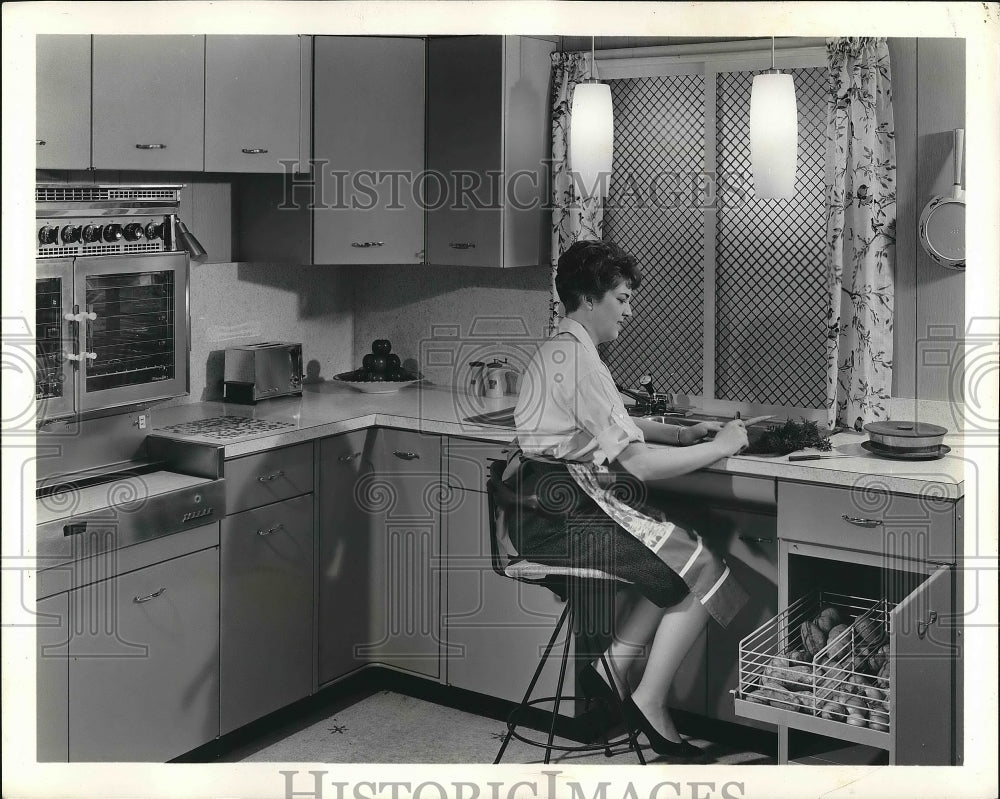 1962 A homemaker at her kitchen workspace  - Historic Images