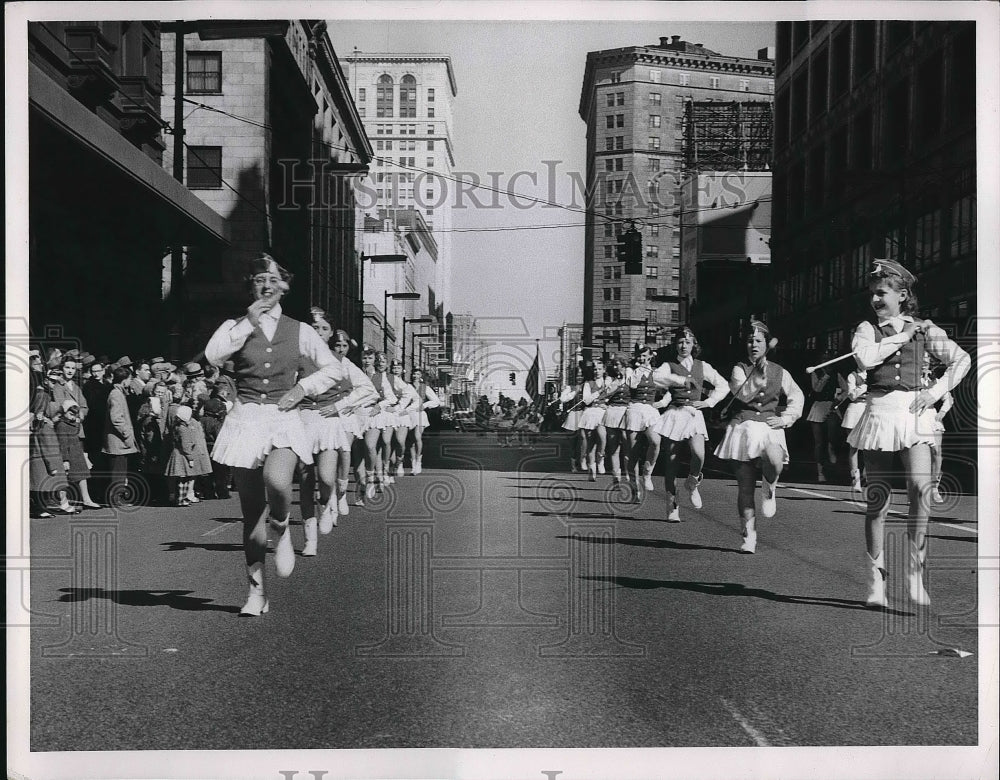1957 A parade working its way down the street  - Historic Images