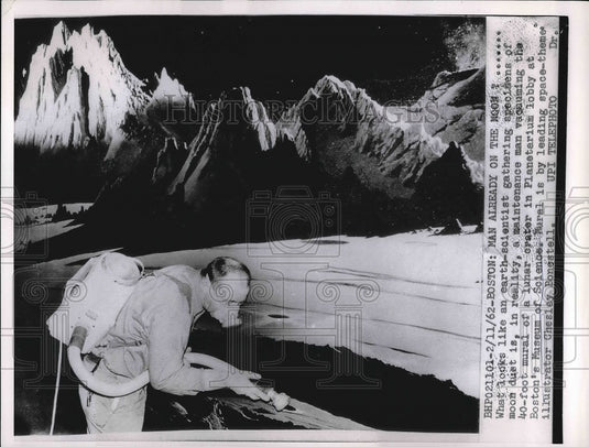 1962 A maintenance man vacuuming exhibit  - Historic Images