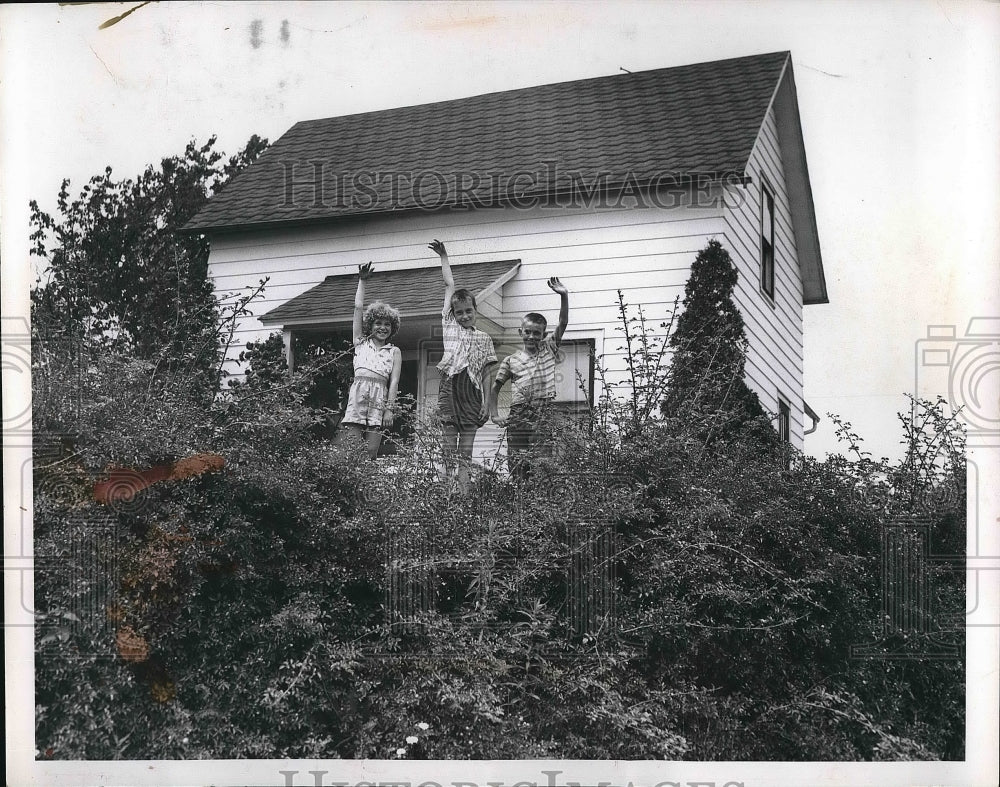 1957 Sharon Nagy, Dennis Liddler and Clarence Nagy in front of house - Historic Images
