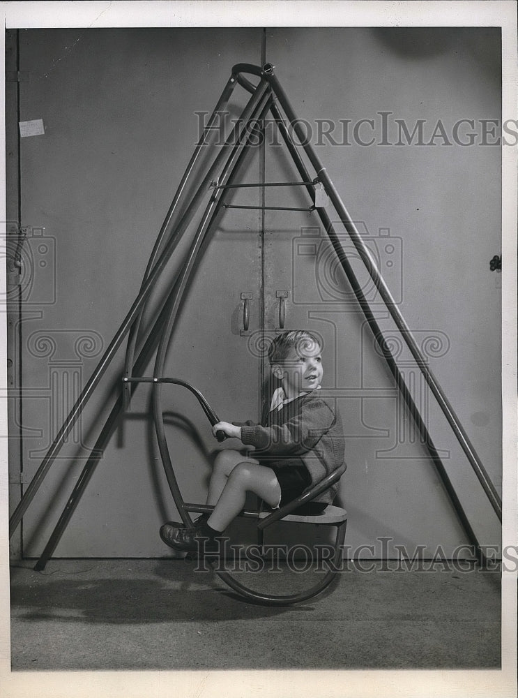 1945 Joel Linderath of Chicago on a metal swing set  - Historic Images