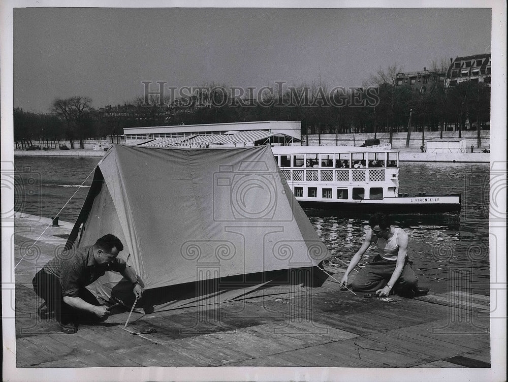 1955 Tourists set up a tent on dock along Seine River, Paris - Historic Images
