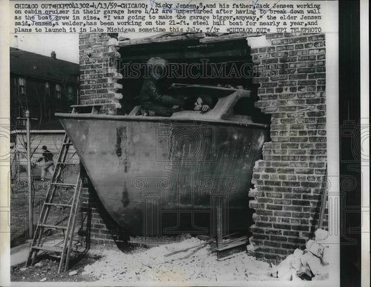 1959 Ricky Jensen, 8, his father, Jack Jensen, work on cabin cruiser - Historic Images