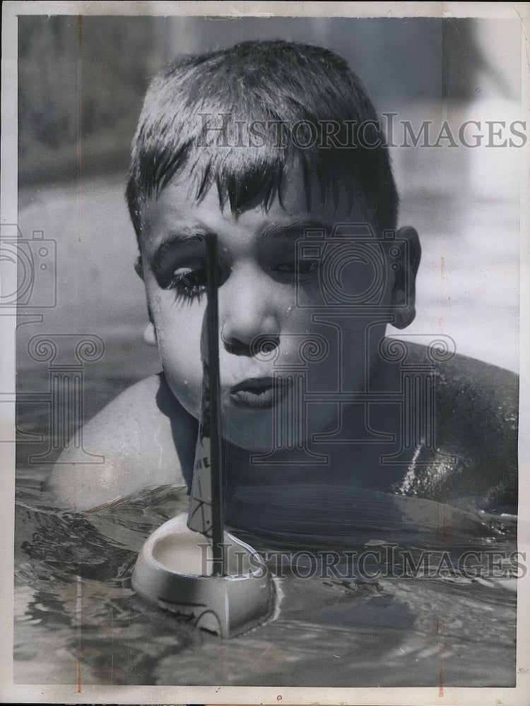 1957 Press Photo It&#39;s No Breeze For Pint Sized Admiral Who Is Blowing His Craft-Historic Images