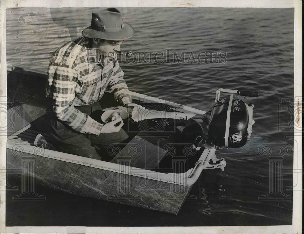 1946 Man showing off an outboard motor  - Historic Images