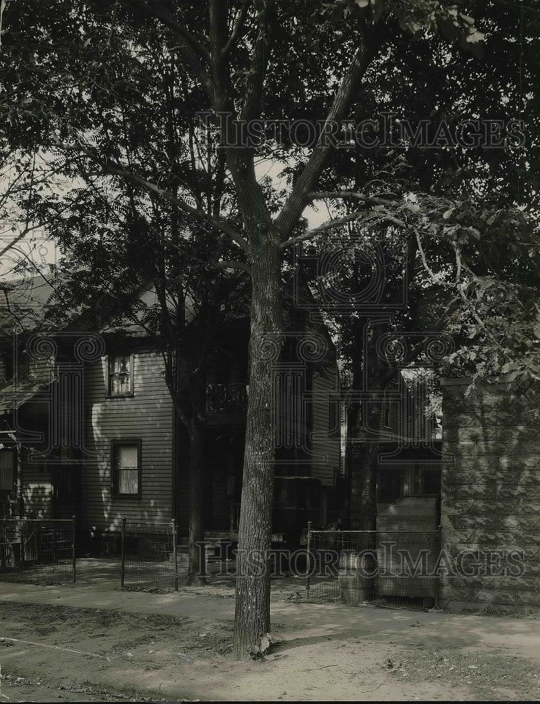 1927 Large tree with house behind  - Historic Images