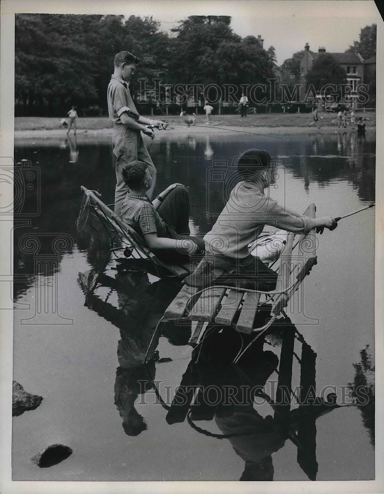1959 To young children fishing during a flood  - Historic Images