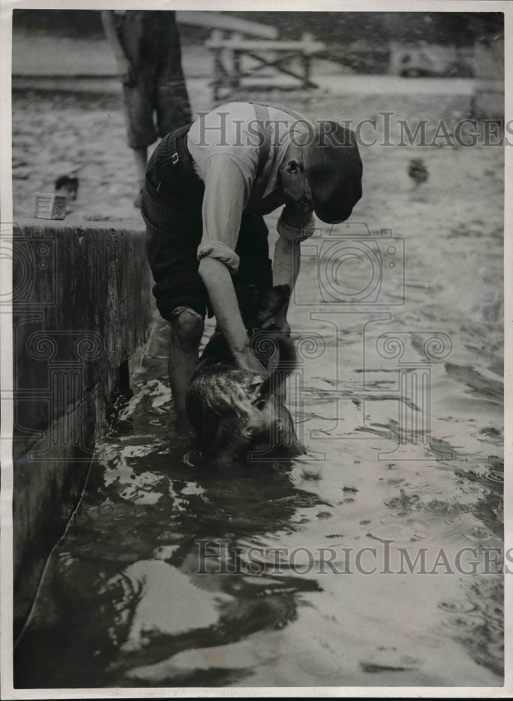 1938 Paris, France man & his pet in the Seine River to cool off - Historic Images