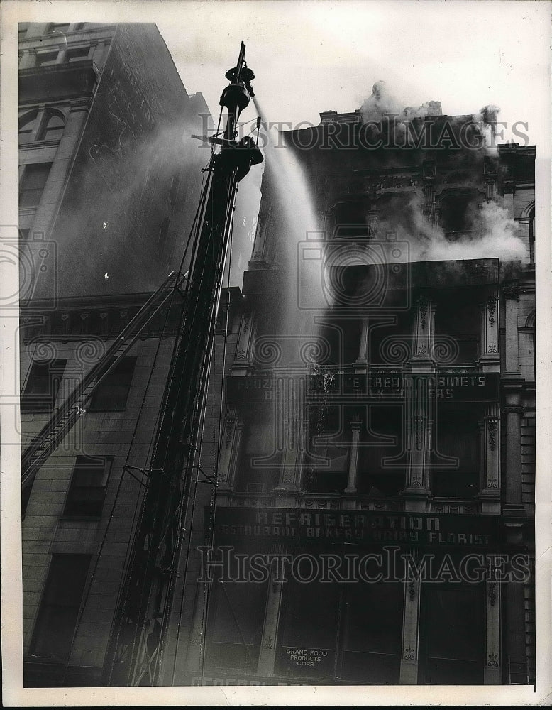 1946 Hot Time Firemen mount water tower to spray water at burning - Historic Images