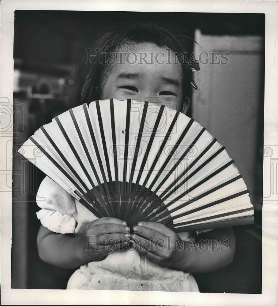 1961 Child Using Oriental Fan in Honolulu, Hawaii  - Historic Images