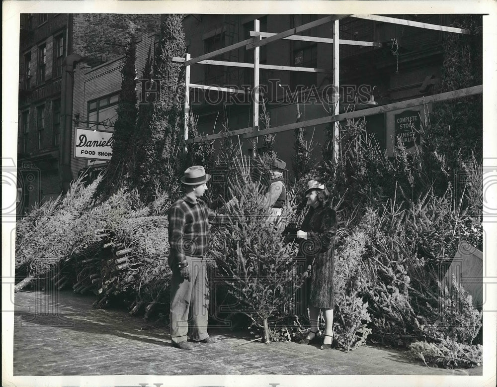 1941 Madeline Lewis selects a Christmas tree in NYC  - Historic Images