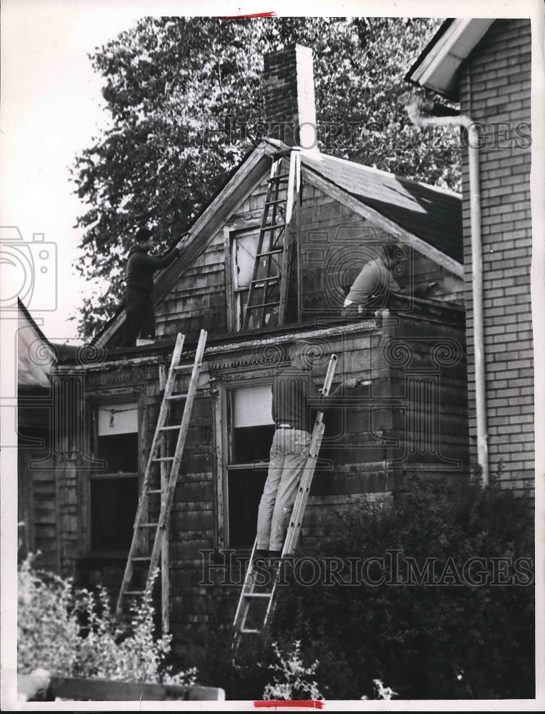 Two men work on restoration of a house  - Historic Images