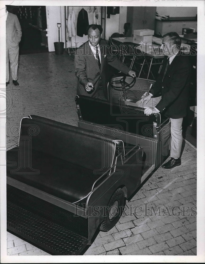 1970 Press Photo Two men standing next to cart - nea89648 - Historic Images