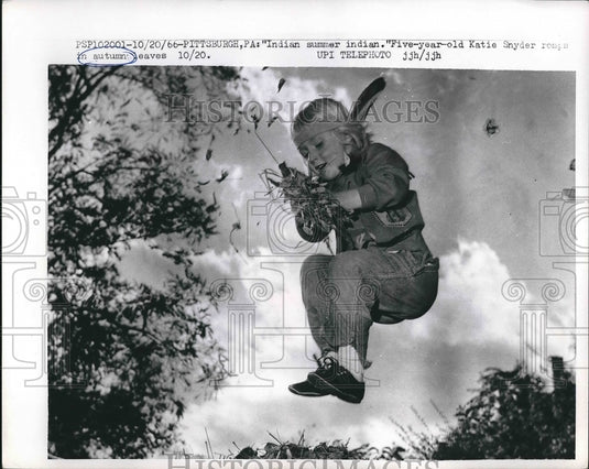 1956 Press Photo Five-year-old Katie Snyder playing in leaves - nea89708 - Historic Images