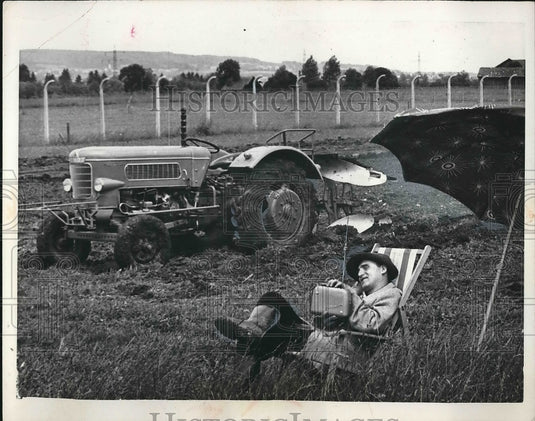 1961 West German Farmers rest in a Beach Chair at Marktonerndorf. - Historic Images