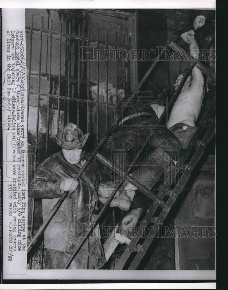 1955 Press Photo Fireman Carry Injured Victim of Comfort Hotel - nea89879 - Historic Images