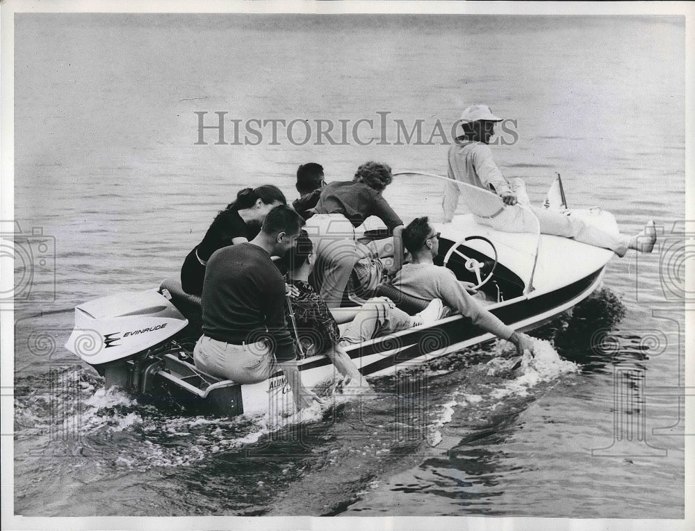 1961 Seven men in small boat against safety rules  - Historic Images