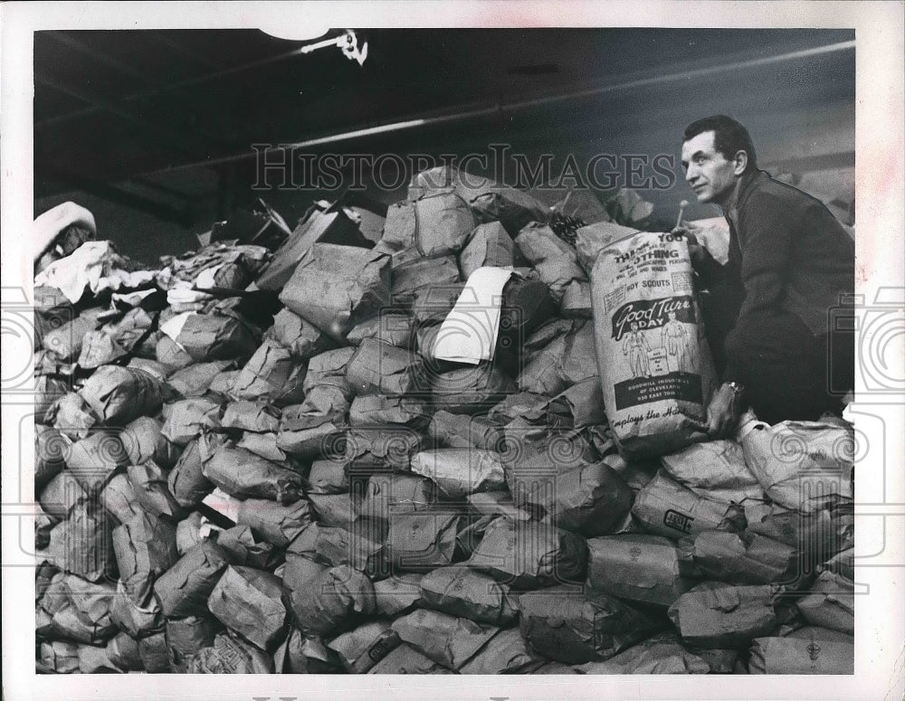 Mato Uherc with packages collected by Boy Scouts for Goodwill Ind. - Historic Images